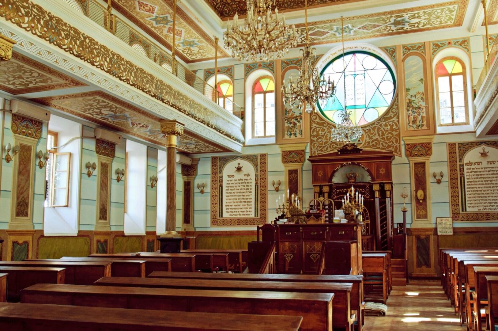 A church with pews and stained glass windows.